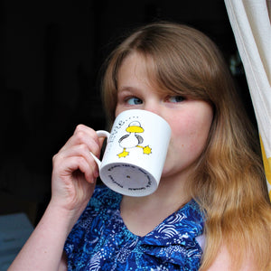 child just turned 12 drinking cocoa from a fun hand painted dancing duck mug by Laura Lee Designs 