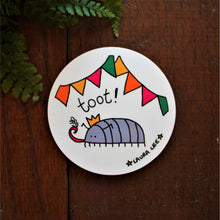 Load image into Gallery viewer, Fun bug coaster high quality round wooden coaster Cyril the woodlouse at a party under colourful bunting wearing a party hat and blowing his tooter
