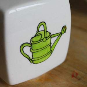 Hand painted watering can on china money box by Laura lee Designs in Cornwall