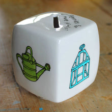 Load image into Gallery viewer, Watering can and victorian cloche hand painted on a cube money box by Laura Lee Designs 