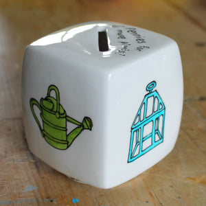 Watering can and victorian cloche hand painted on a cube money box by Laura Lee Designs 