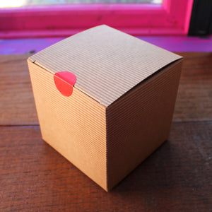 Brown kraft box with red sticker seal