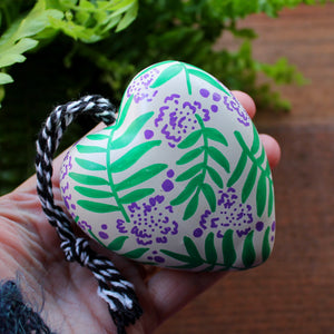 Decorative hanging heart lilac flowers and green ferns