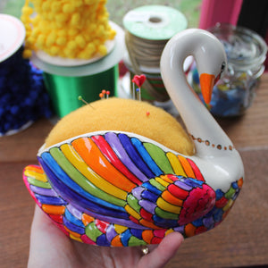 Rainbow feather detail on a china swan pin cushion hand painted by Laura Lee Designs Cornwall