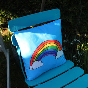 Colourful rainbow cushion on a garden chair by Laura Lee Designs in Cornwall